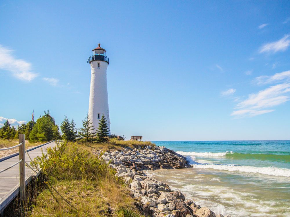 Empty path leading to white lighthouse on Lake Superior coast