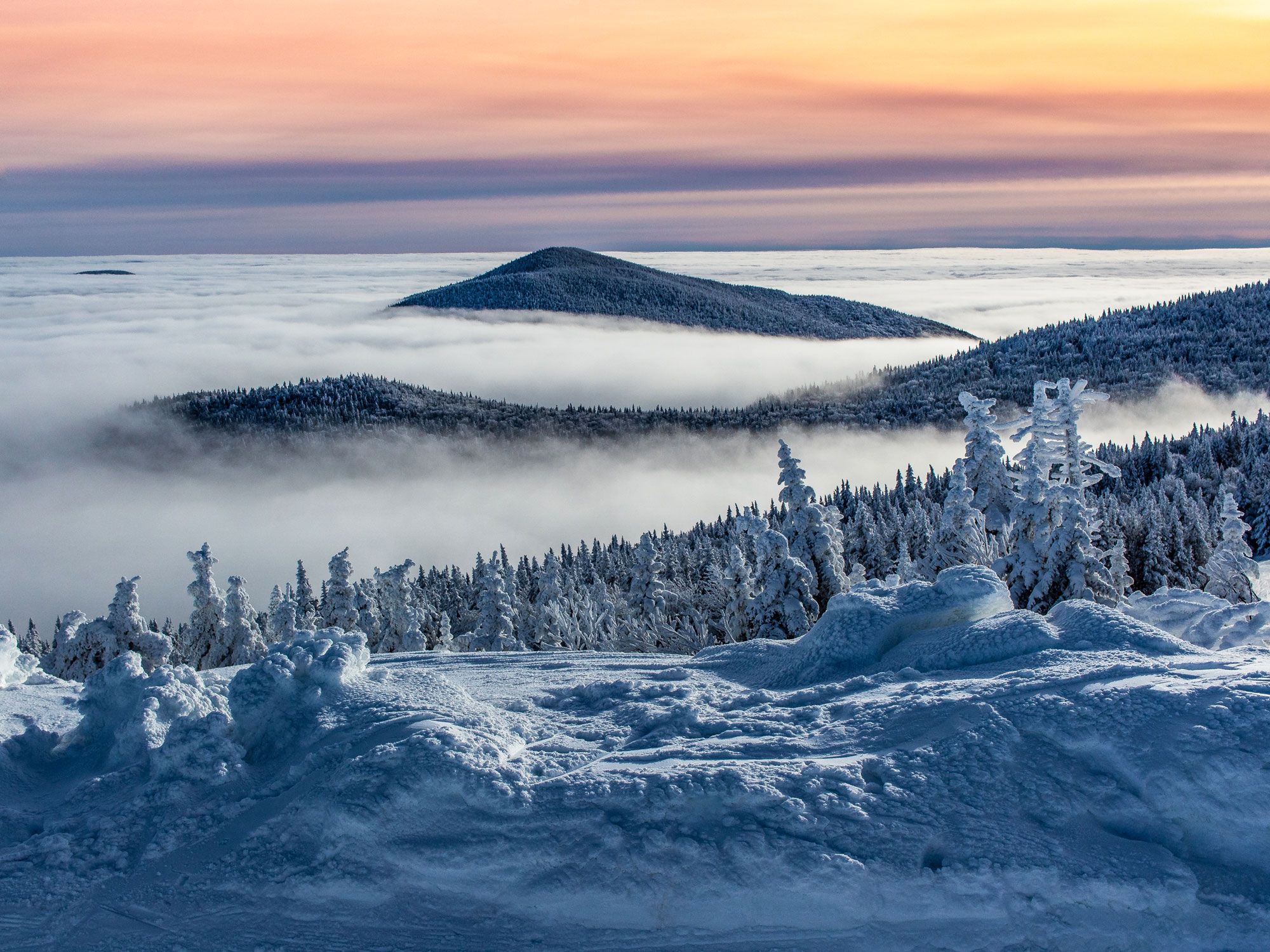 Snowy Vermont mountain landscape at sunset, seen from above