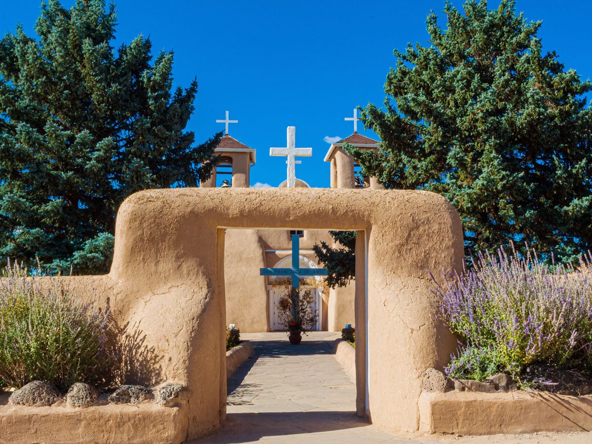 Adobe archway leading to church in Taos Pueblo