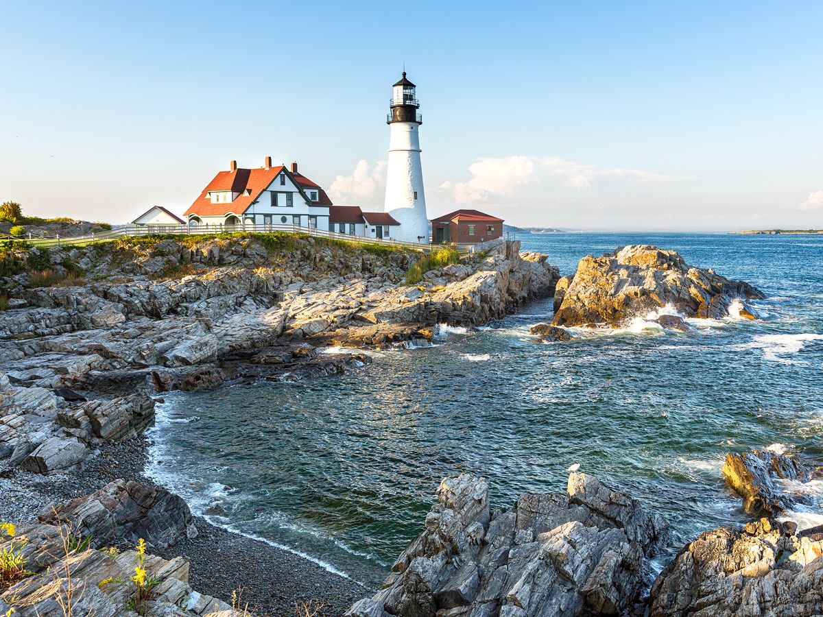 White lighthouse along rocky coast of Maine