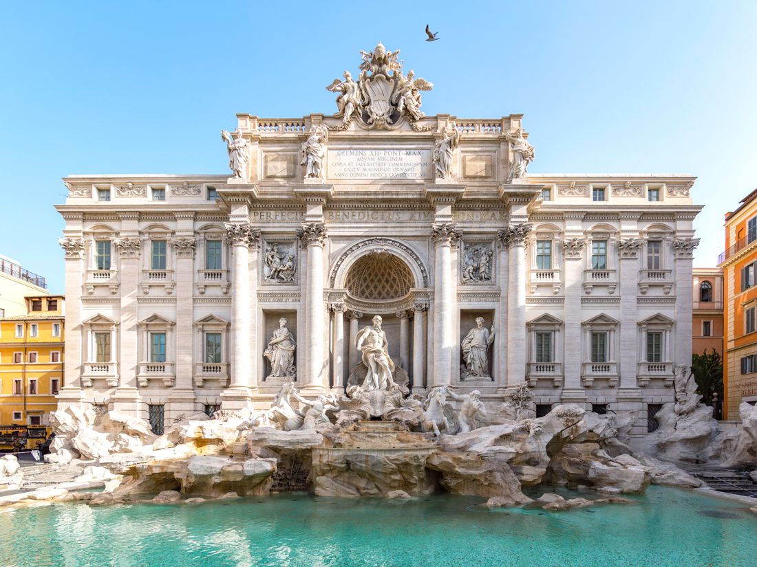 Ornate statues and building lining the Trevi Fountain in Rome, Italy