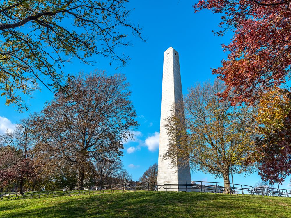 Bunker Hill Monument framed by trees in Charlestown, Massachusetts