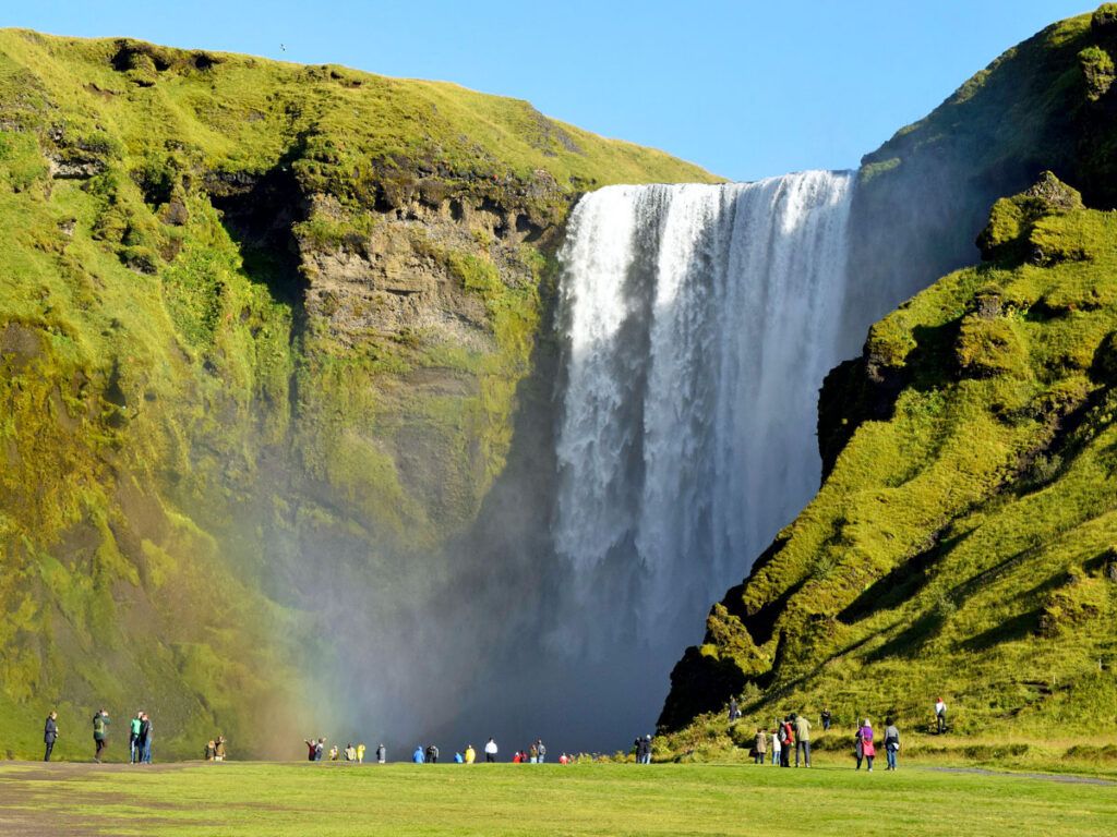 Tourists admiring waterfall in Iceland