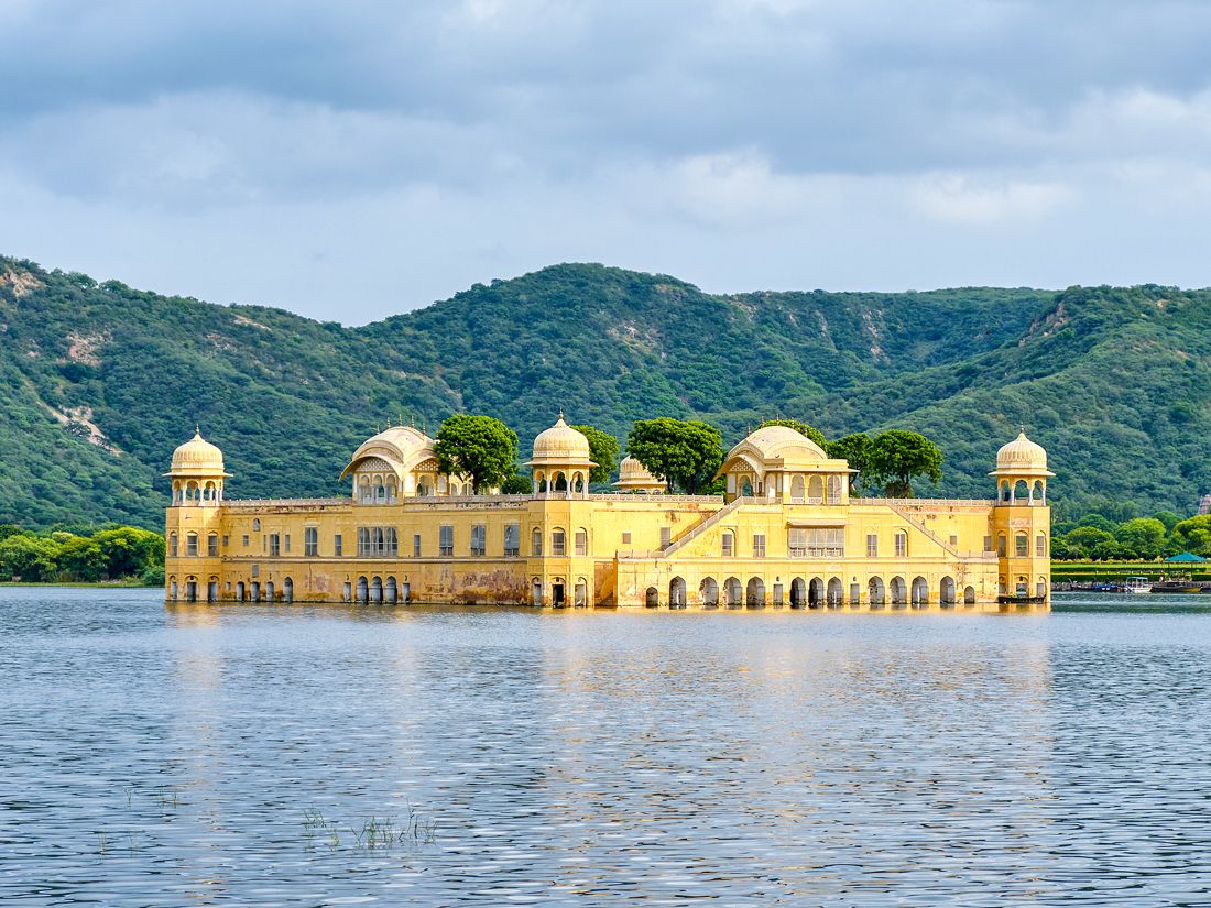 Yellow-painted Jal Mahal palace floating in lake in Jaipur, India