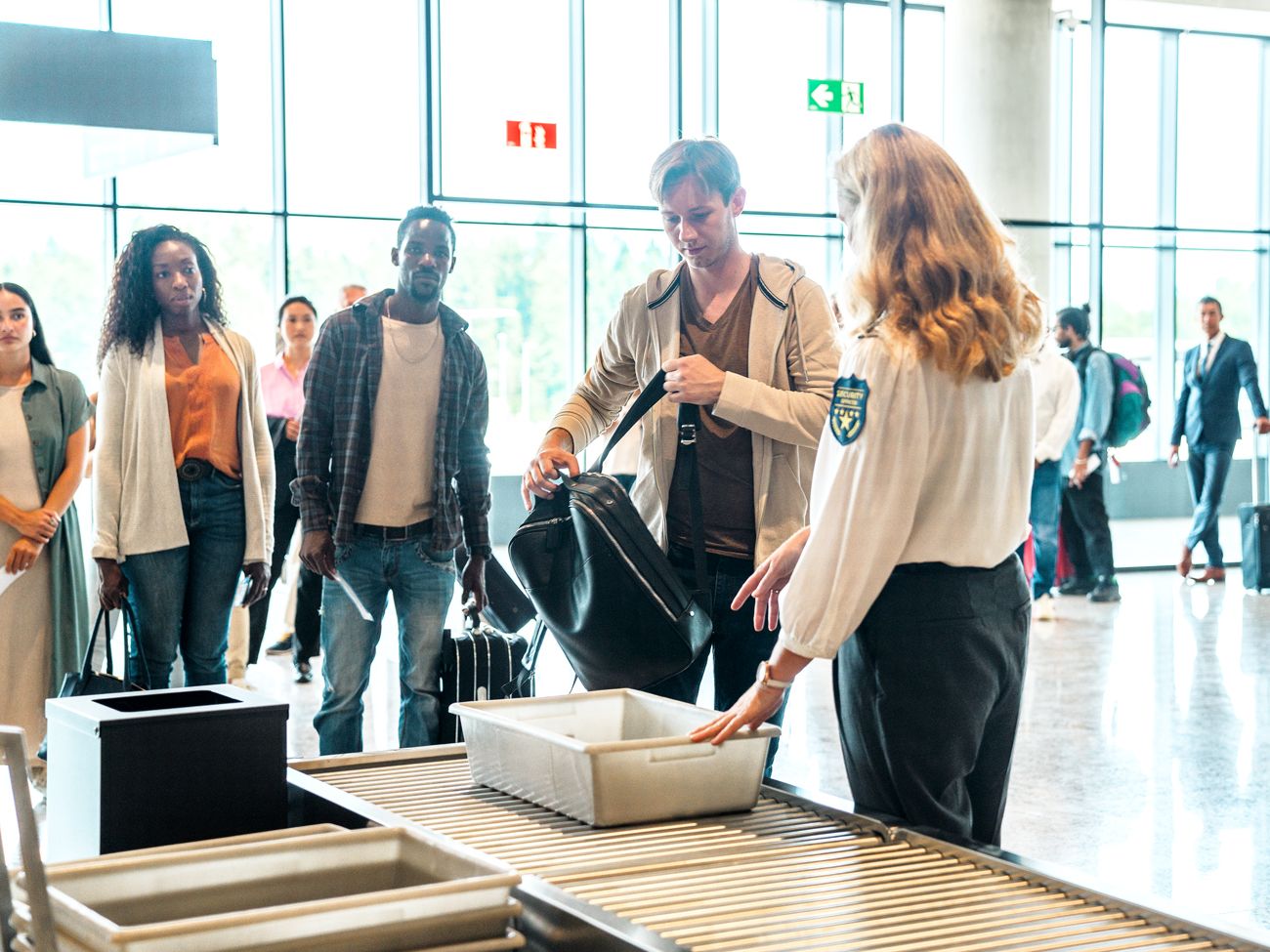 Travelers passing through security line at airport