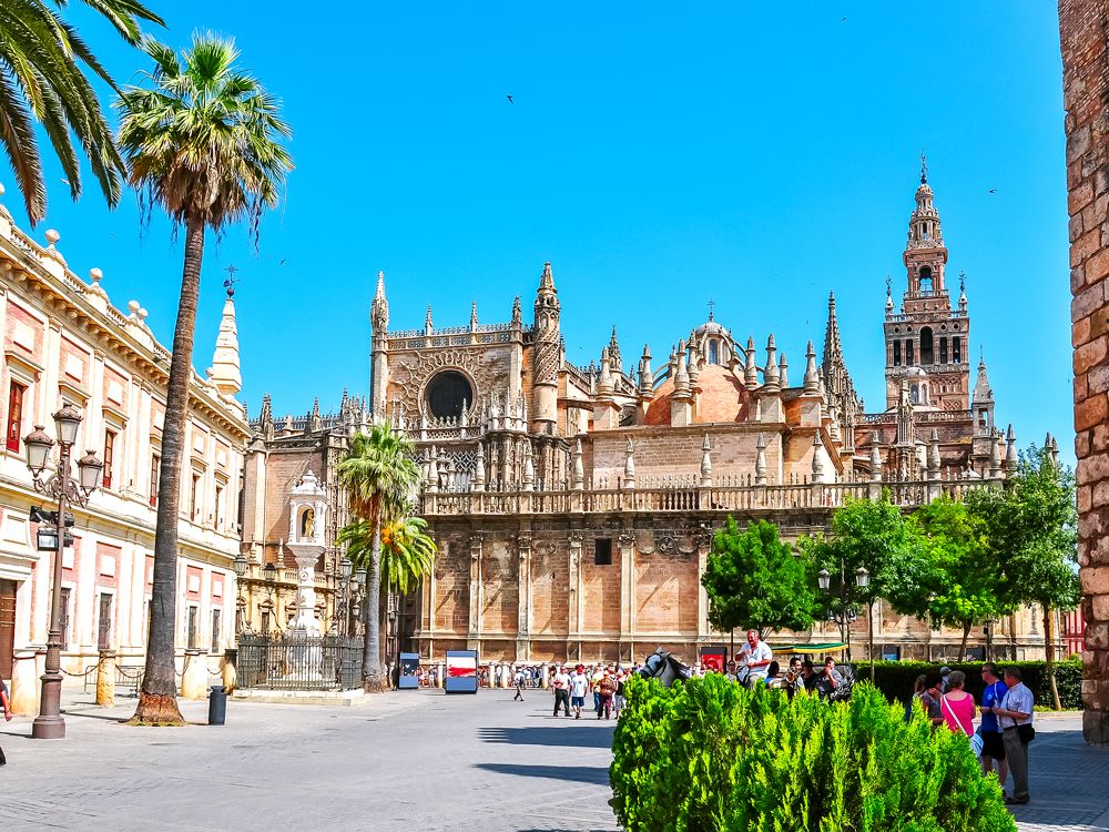 People in plaza in front of Seville Cathedral in Spain