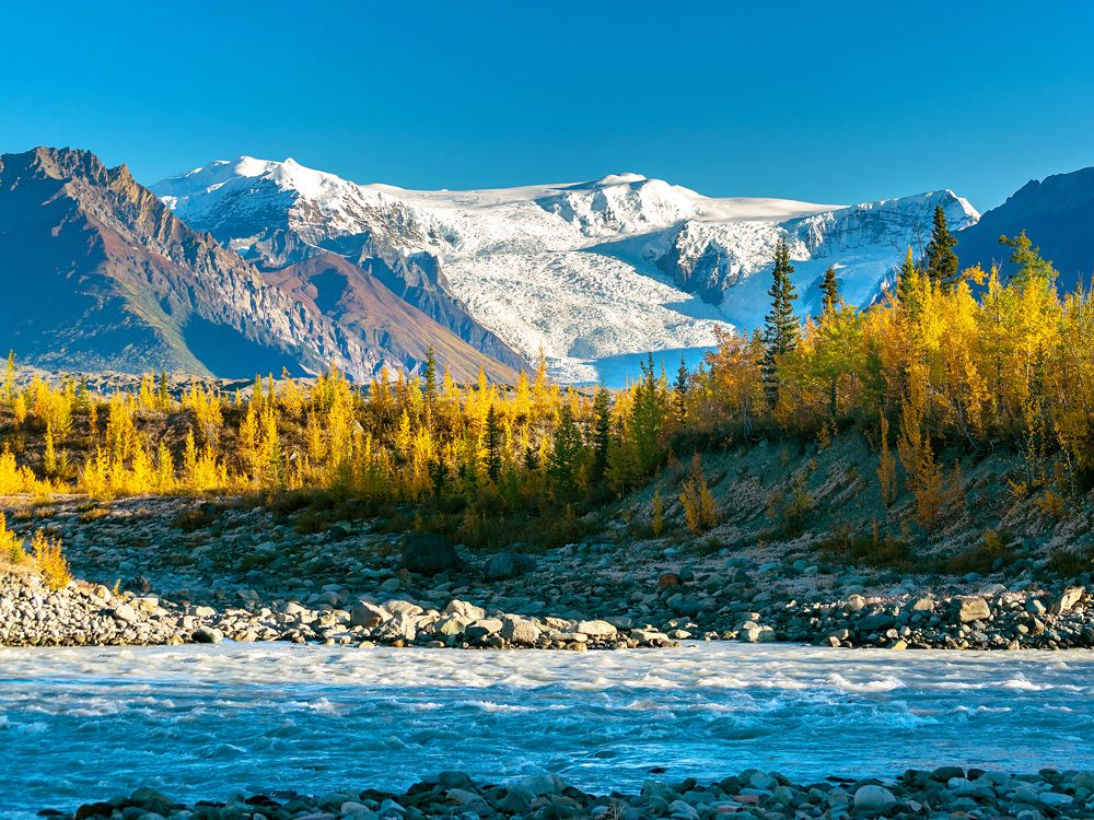River, forest, and snow-capped mountain peaks in Wrangell-St. Elias National Park and Preserve, Alaska