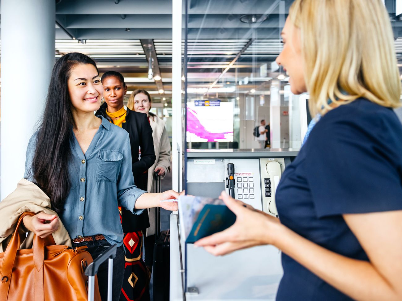 Passenger handing identification to airport agent