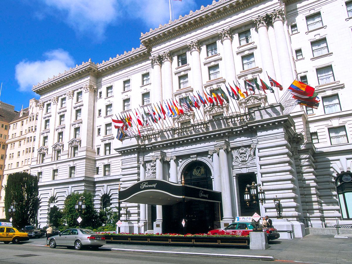 International flags flying above entrance to Fairmont San Francisco hotel