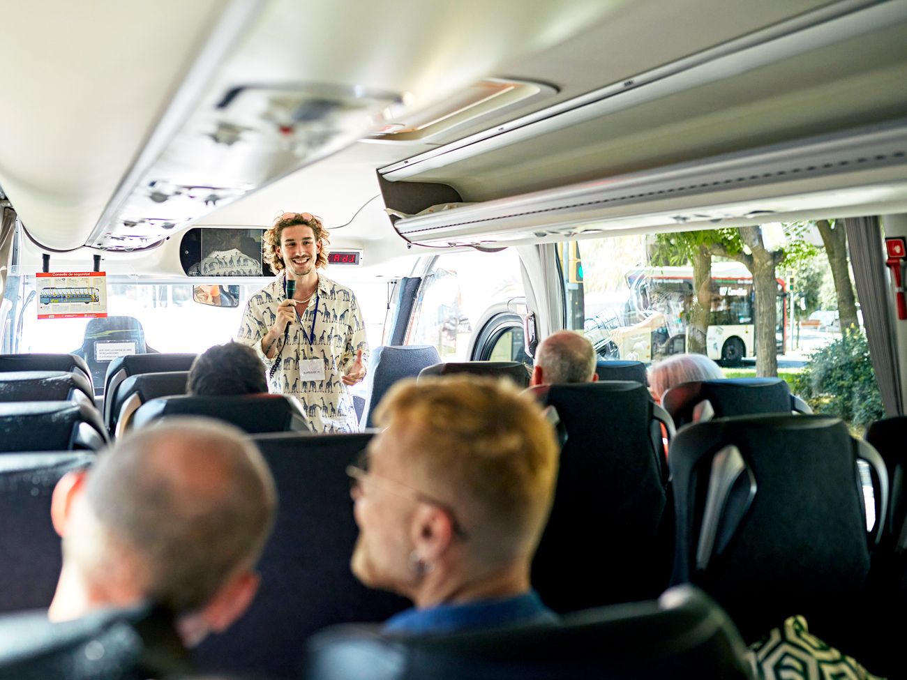 Guide speaking to tour group on bus