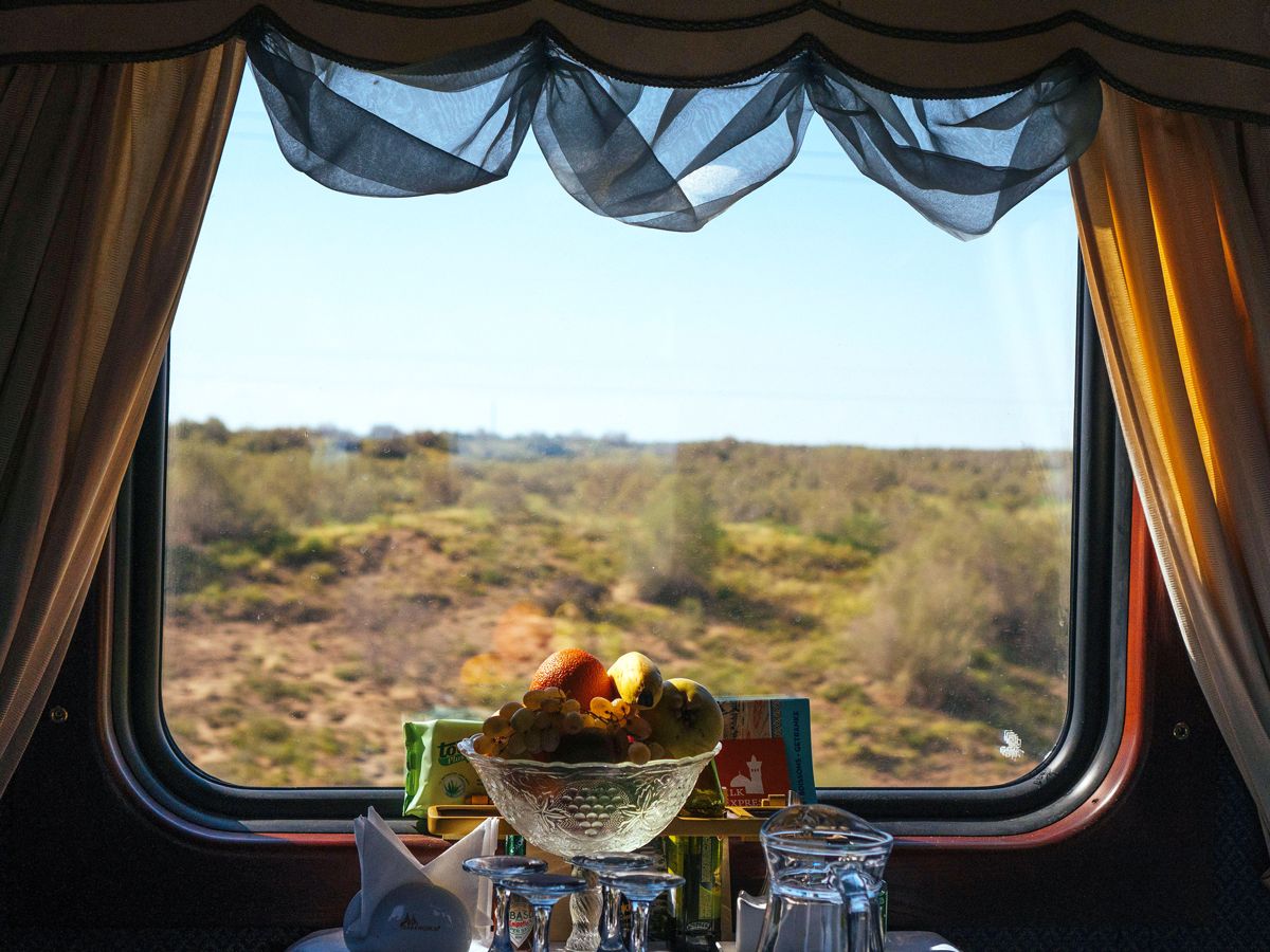 Glassware in train car with view out of window