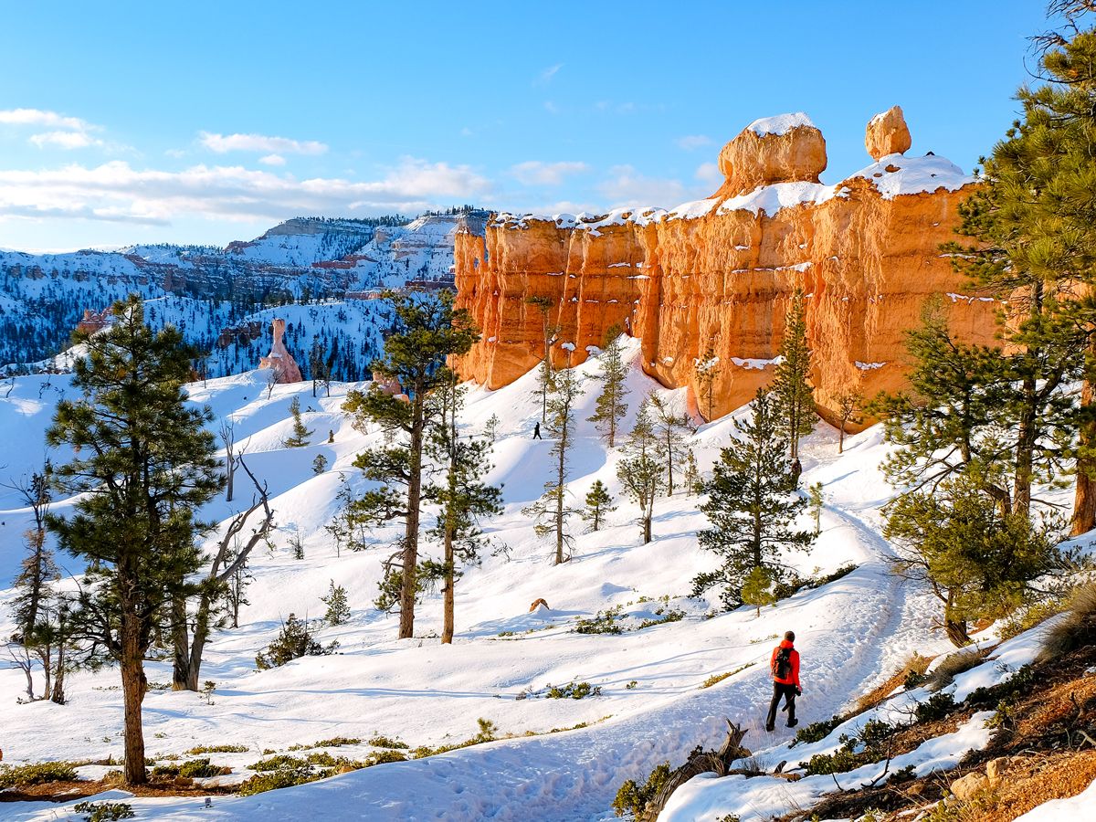 Hiker on snow-covered trail in Bryce Canyon National Park, Utah