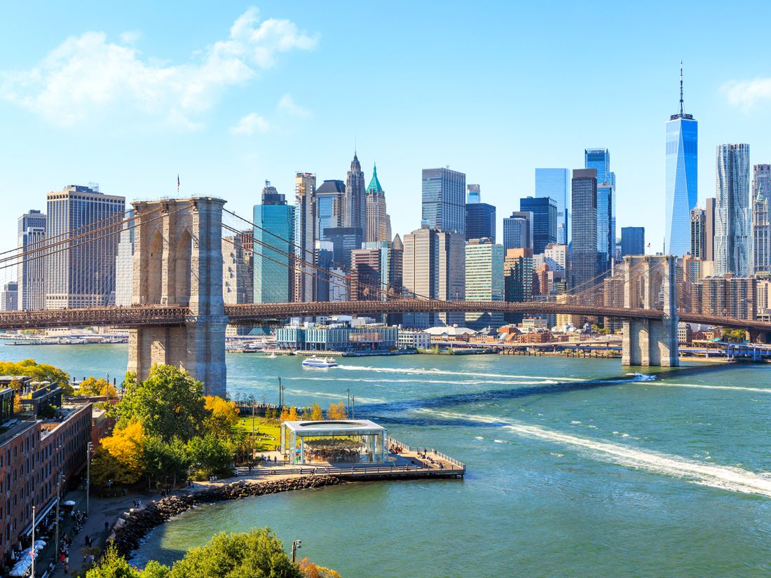 Brooklyn Bridge over East River with Manhattan skyline behind