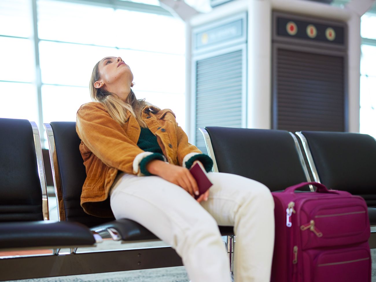 Airline passenger sitting at boarding gate