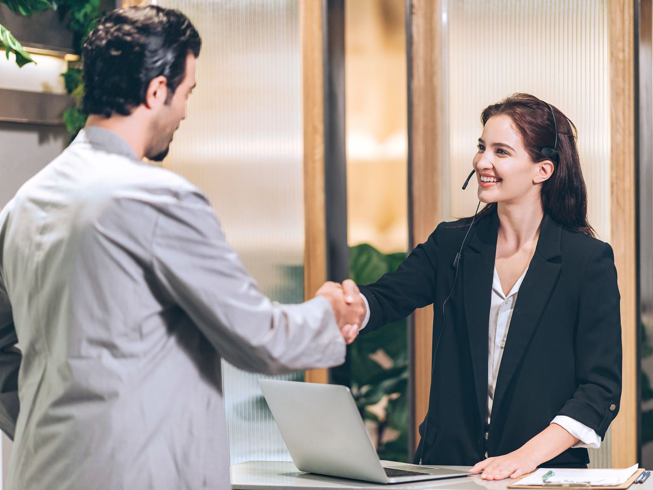 Hotel guest shaking hands with staff