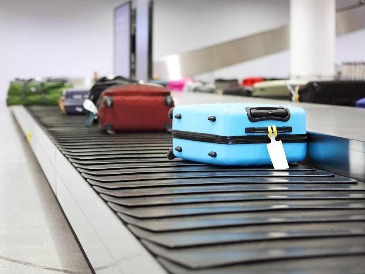 Suitcases on airport baggage claim carousel