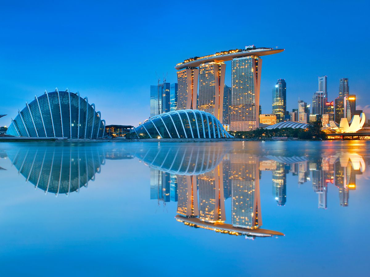 Skyline of Singapore reflecting on bay at night