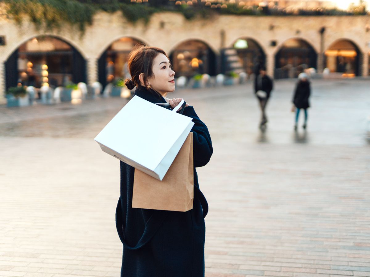 Woman holding shopping bags on European street