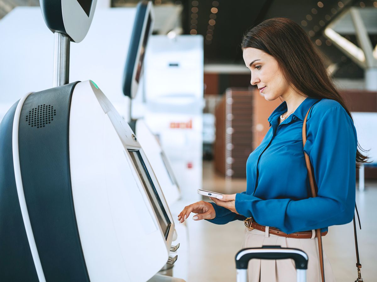 Passenger using airport check-in kiosk