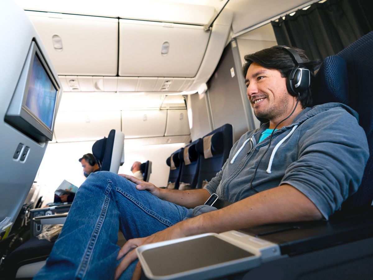 Airline passenger watching seatback entertainment screen