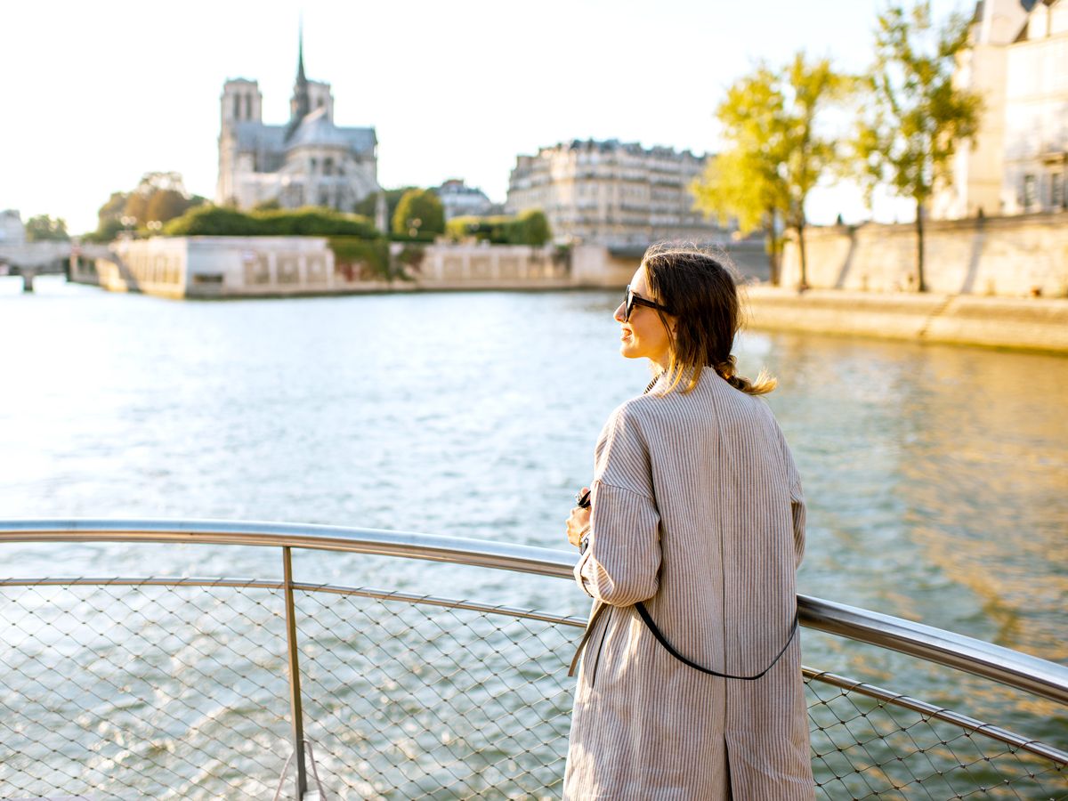 Traveler looking out over river and cityscape