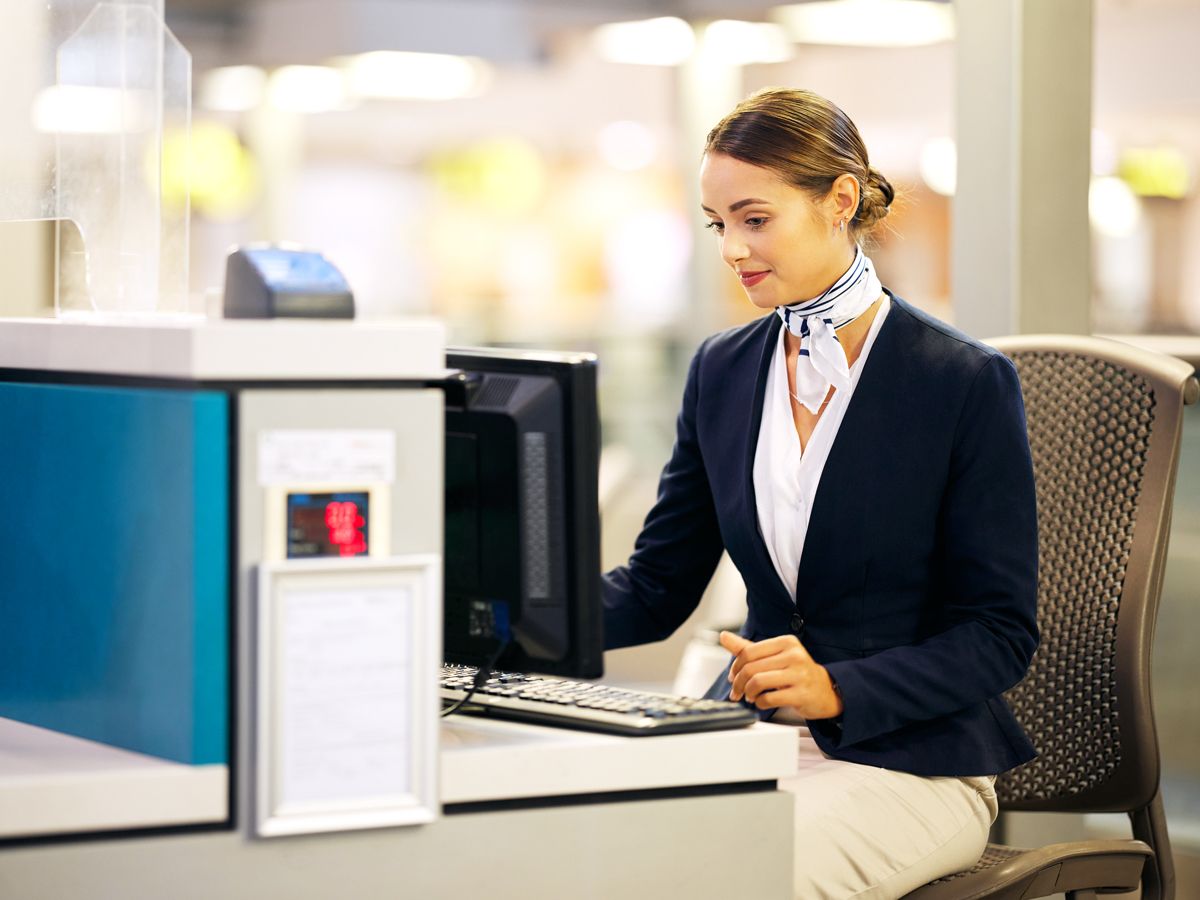 Airport check-in agent working on computer