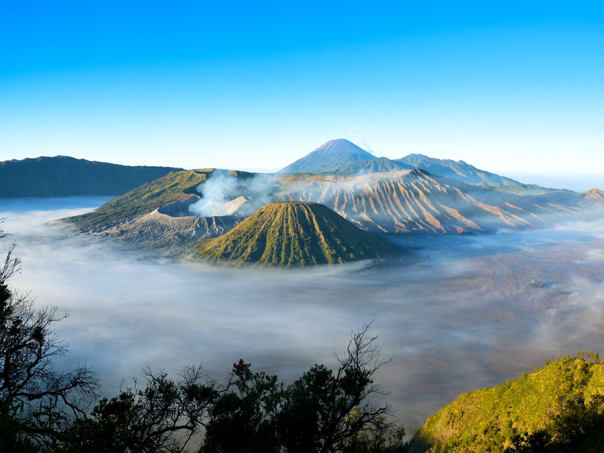 Aerial view of Mount Bromo in Indonesia partially covered in clouds