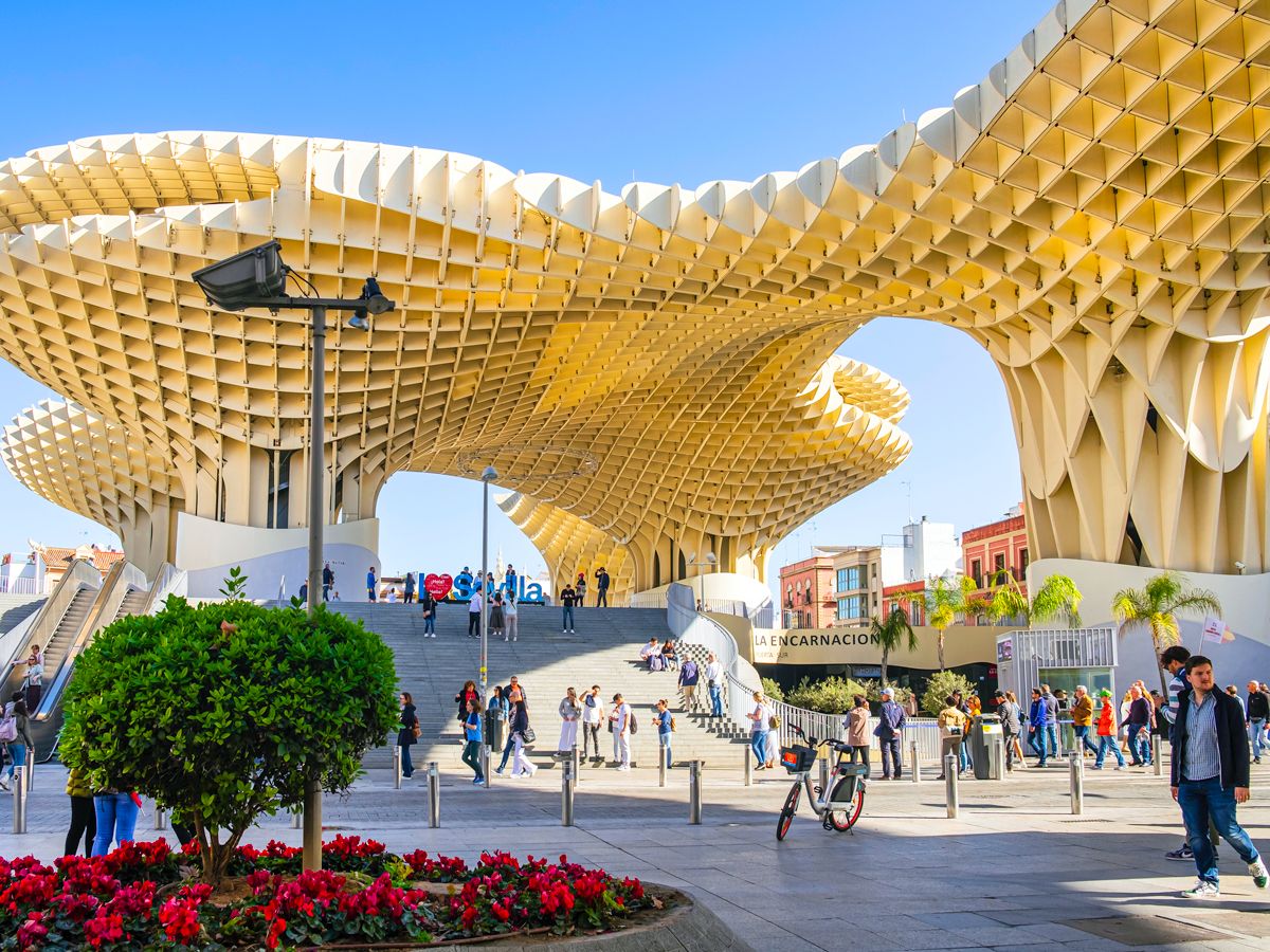 People walking under Setas de Sevilla in Spain
