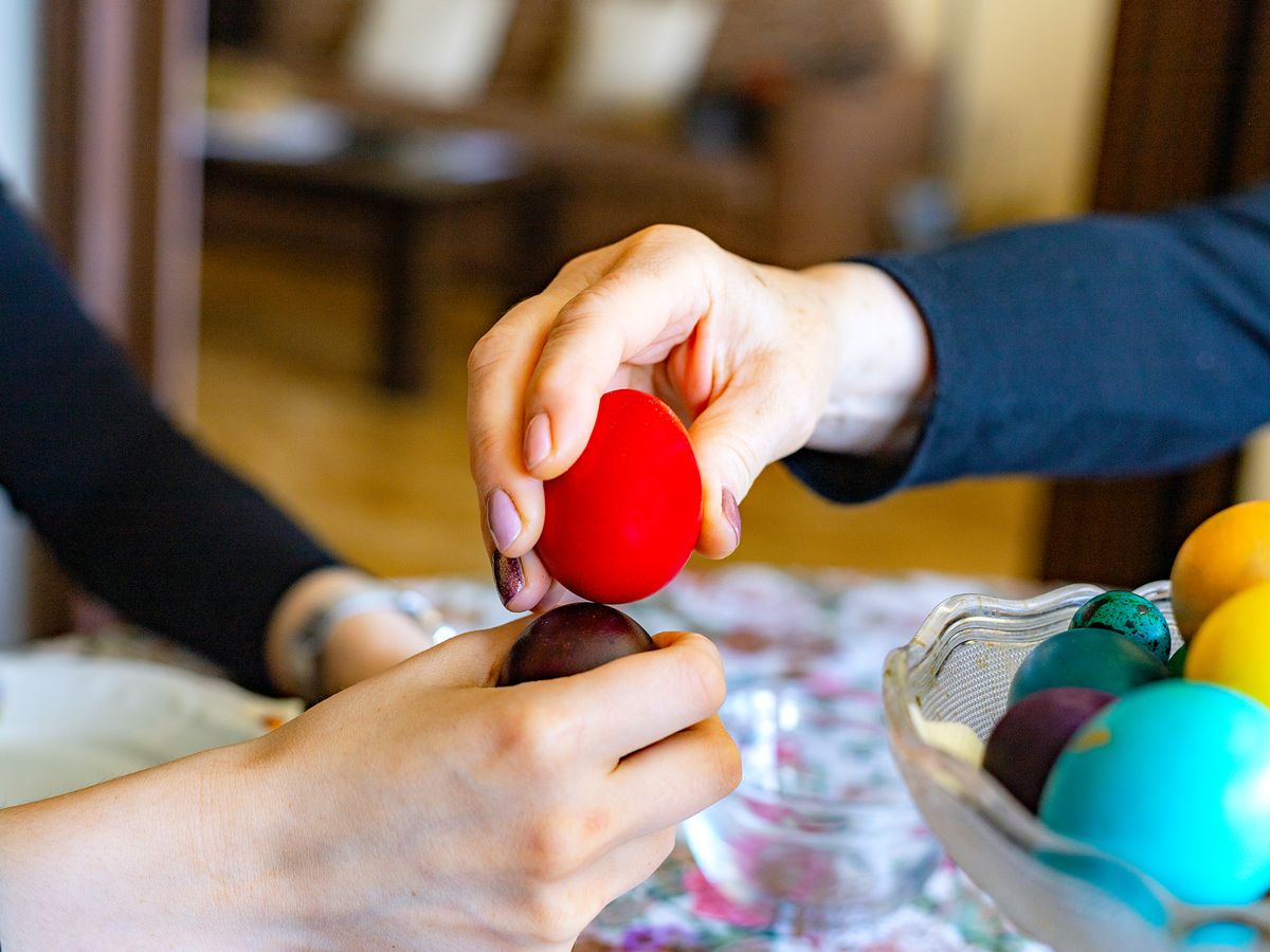 People holding painted Easter eggs