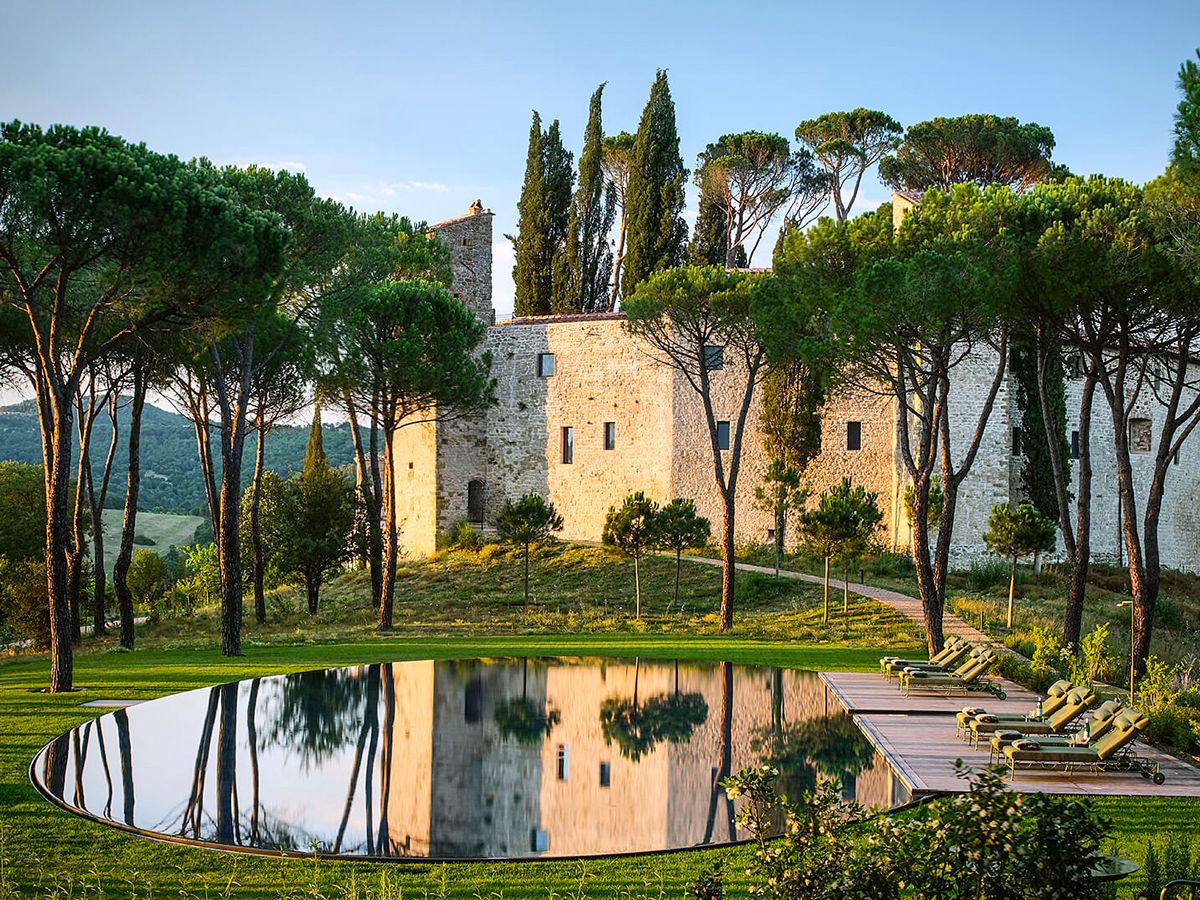 Swimming pool reflecting Castello di Reschio in Umbria, Italy