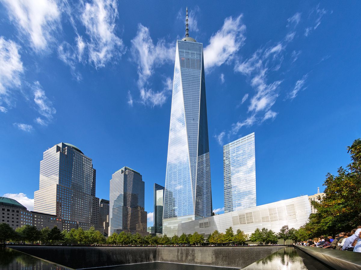 One World Trade Center towering above 9/11 Memorial in New York City