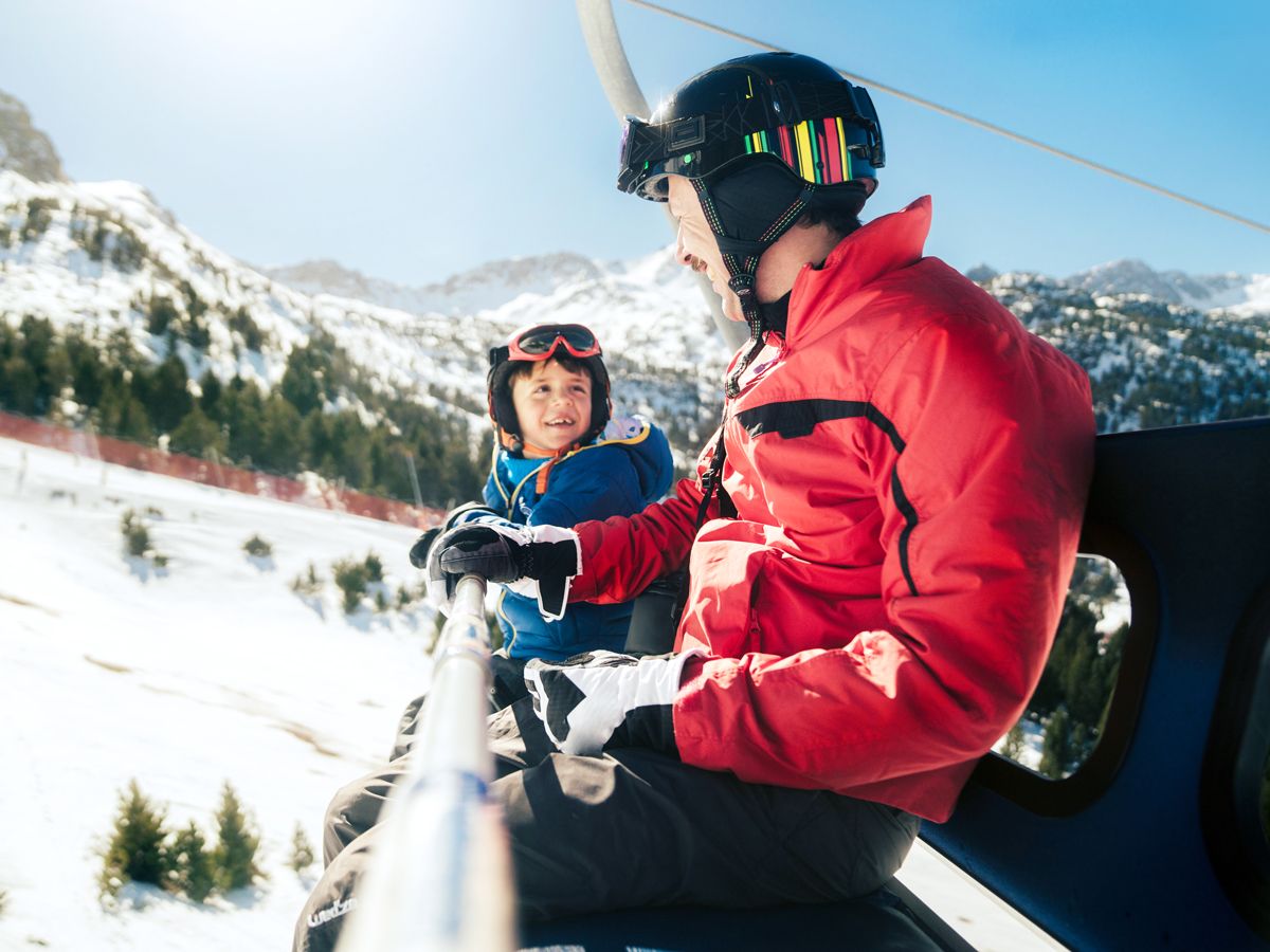 Father and son on chairlift to go skiing