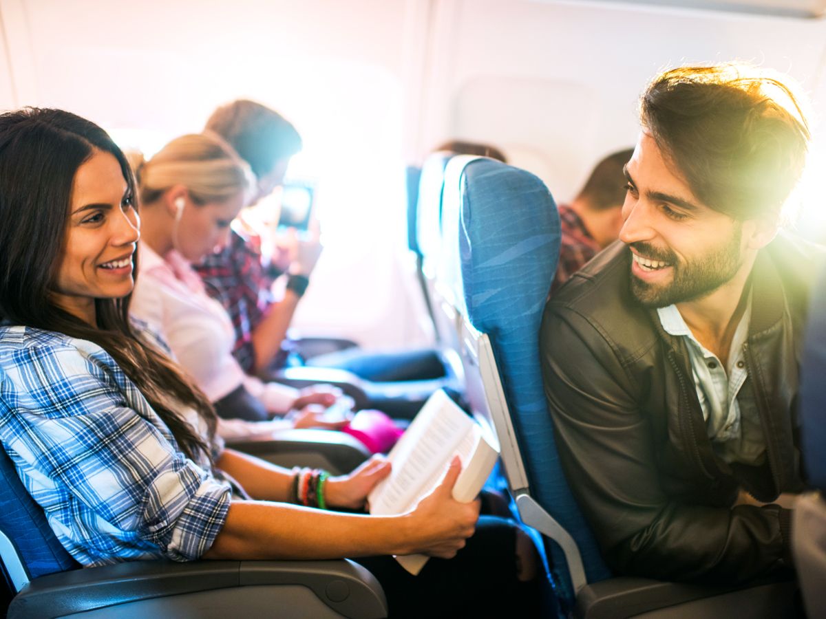 Passengers conversing on airplane