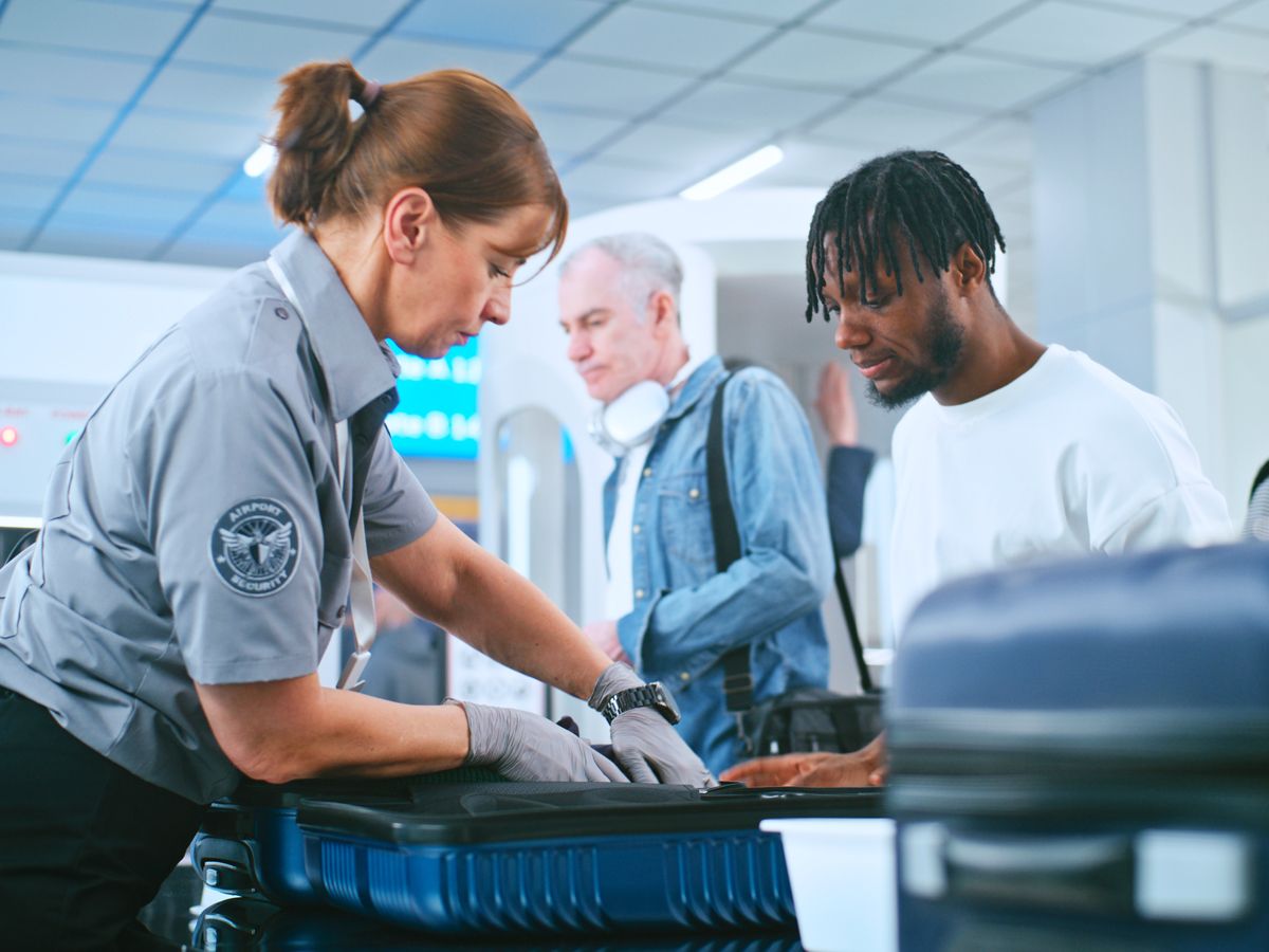 Passengers undergoing security screening at airport