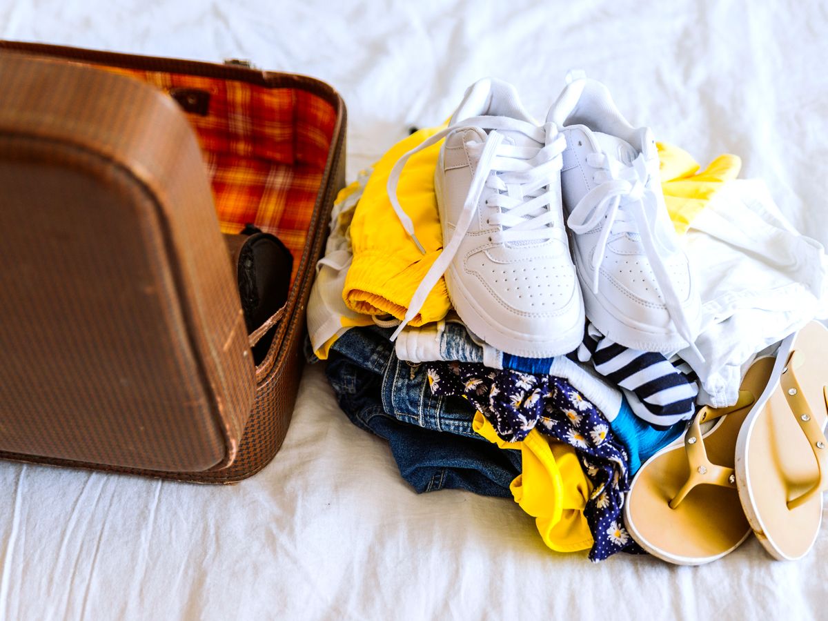 Shoes laid out next to suitcase