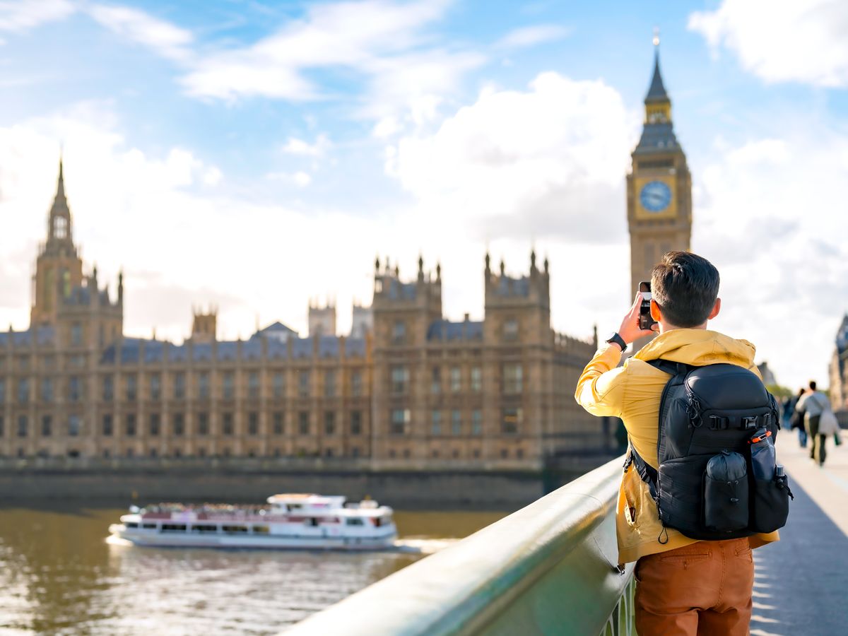 Tourist capturing photo of Big Ben in London, England