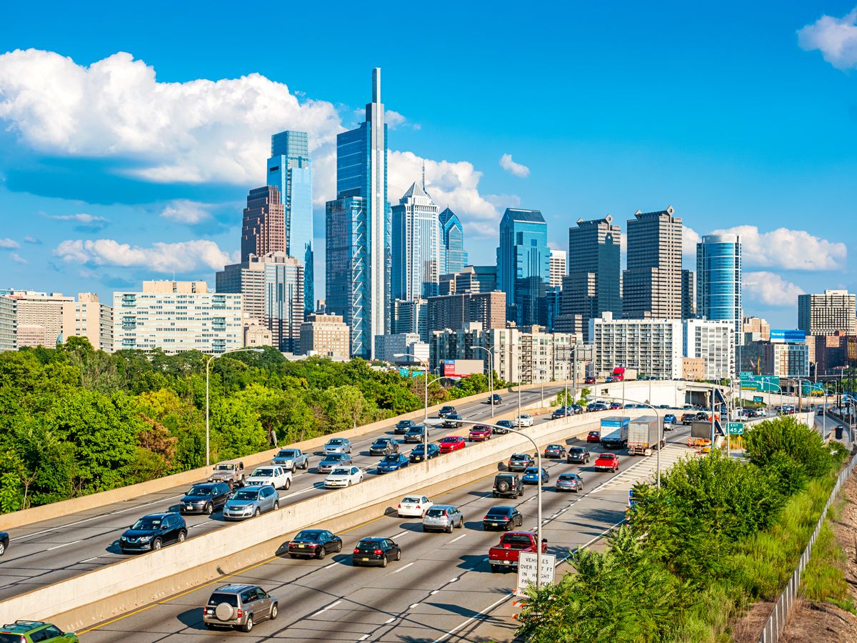 Busy interstate with Philadelphia skyline in background