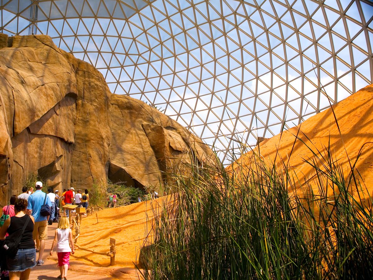 Visitors walking through glass domed exhibit at Henry Doorly Zoo in Omaha, Nebraska