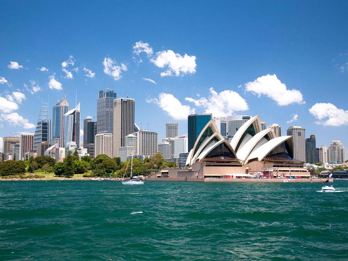 Sydney Opera House and skyline of Sydney, Australia, seen across harbor