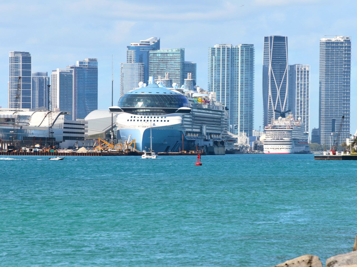 Cruise ship docked at PortMiami with Miami skyline in background