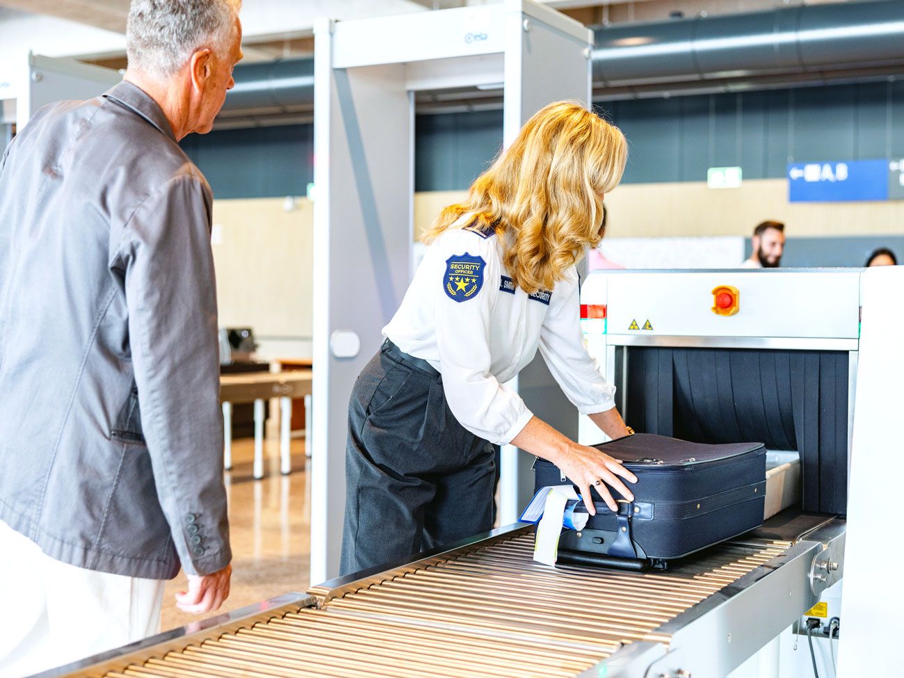 TSA officer screening baggage at airport