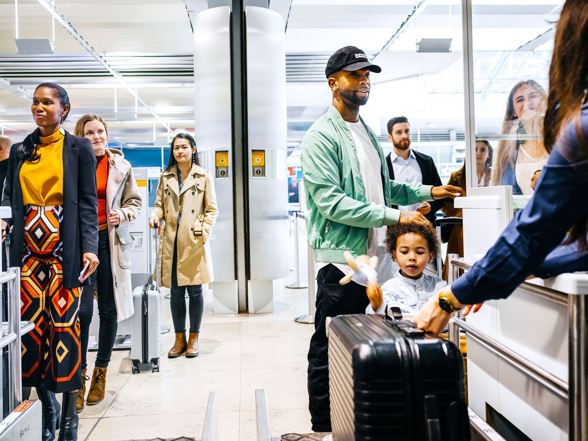 Passengers in security screening line at airport