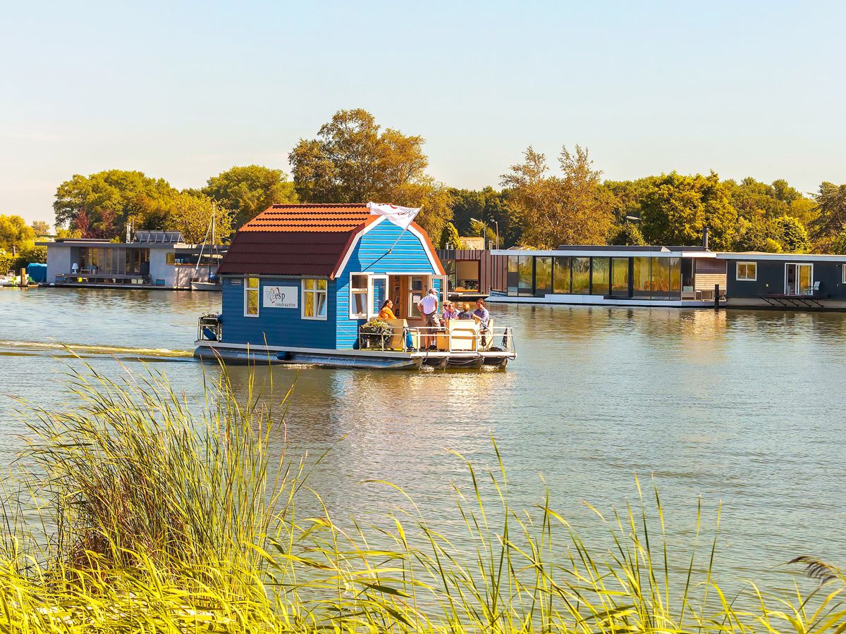 Blue houseboat cruising on lake