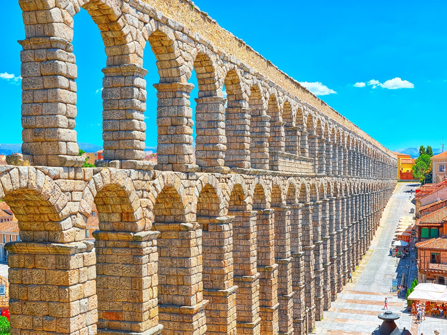 Ancient Aqueduct of Segovia, Spain, under sunny sky