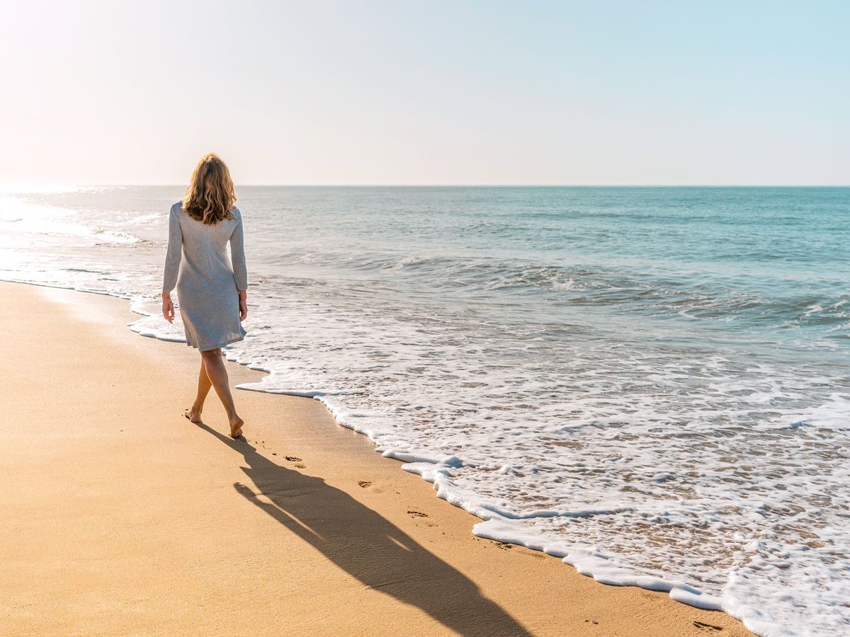 Woman walking on sandy beach