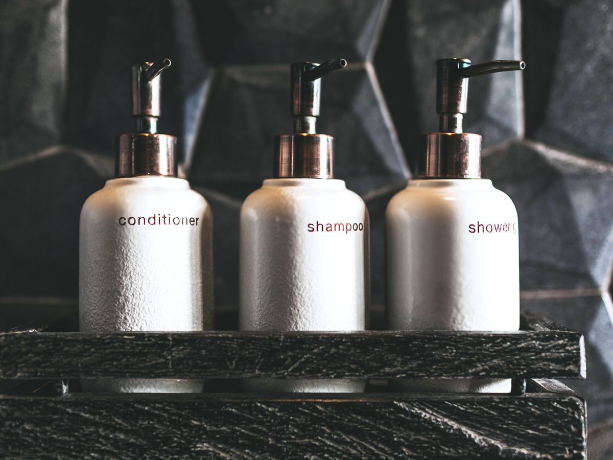 Bottles of conditioner, shampoo, and shower gel