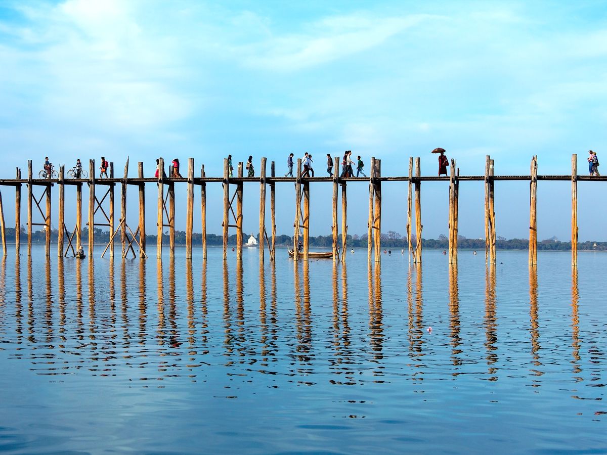 People walking across U Bein Bridge in Myanmar