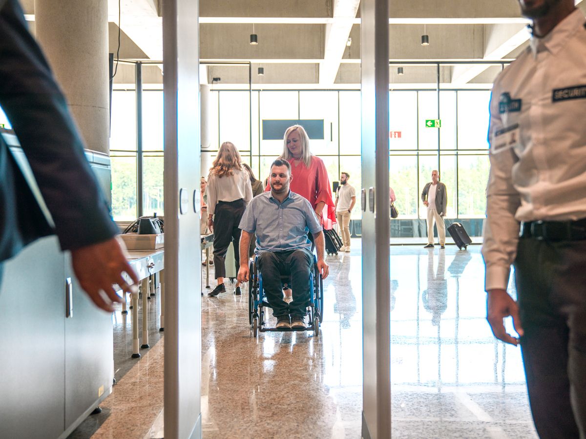 Passenger using wheelchair at airport security checkpoint