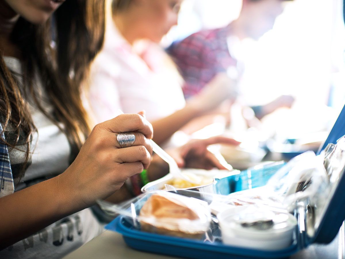 Airline passenger eating meal off tray table
