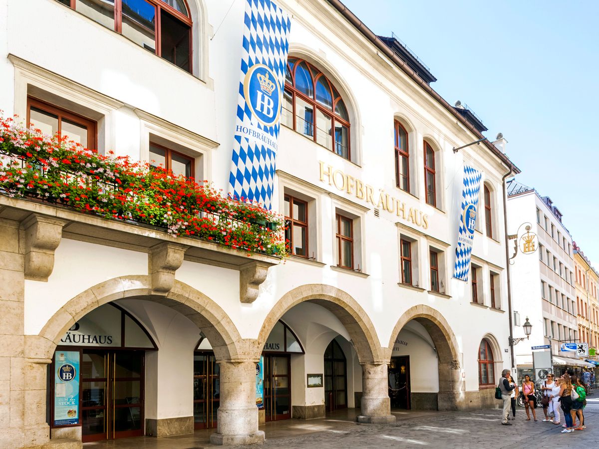 Exterior of Hofbräuhaus in Munich, Germany, with flags hanging